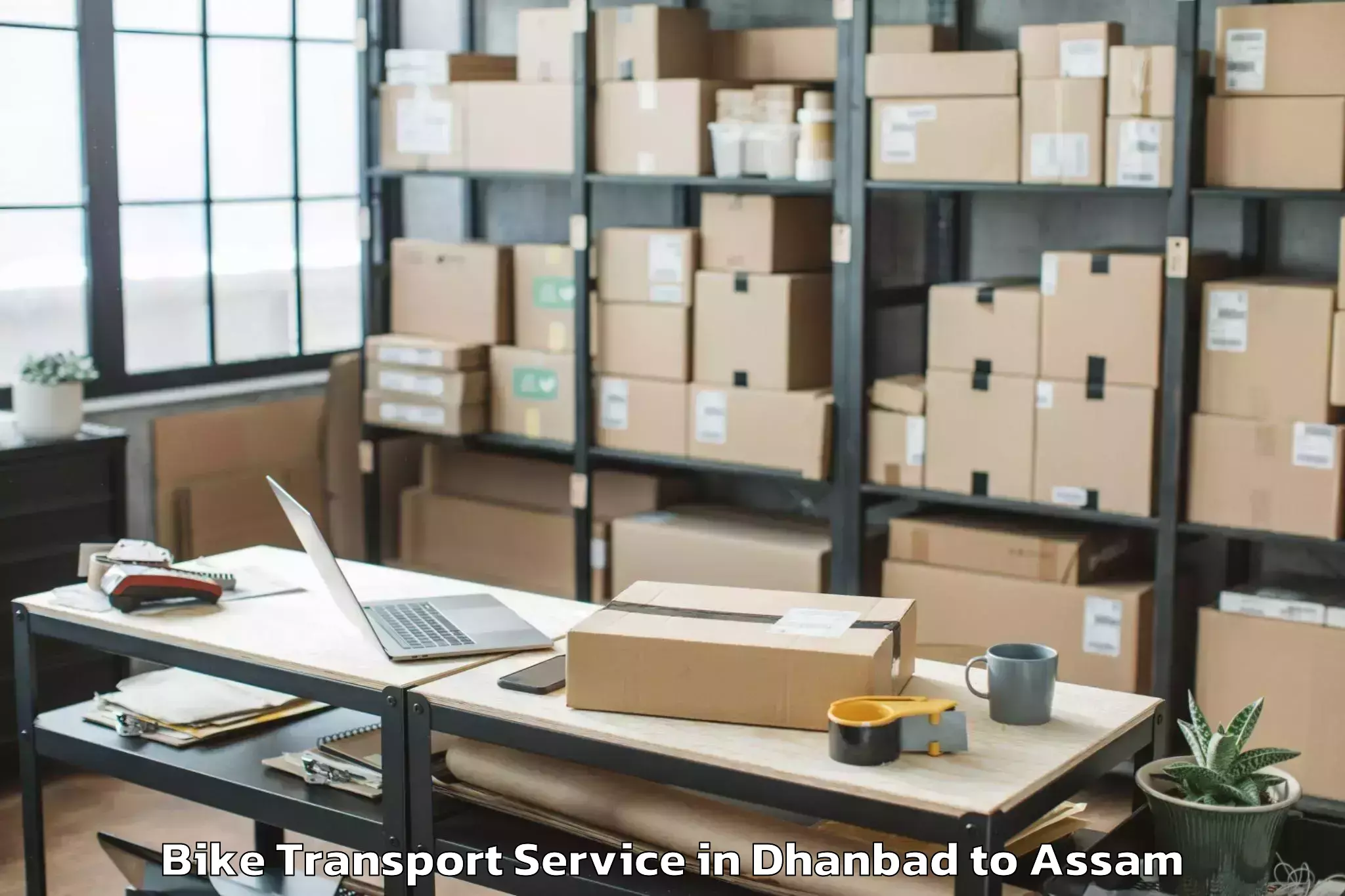 Book Dhanbad to Golokganj Pt Bike Transport Online